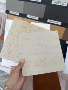 Interior designer selecting customized flexible stone panel samples for a client project