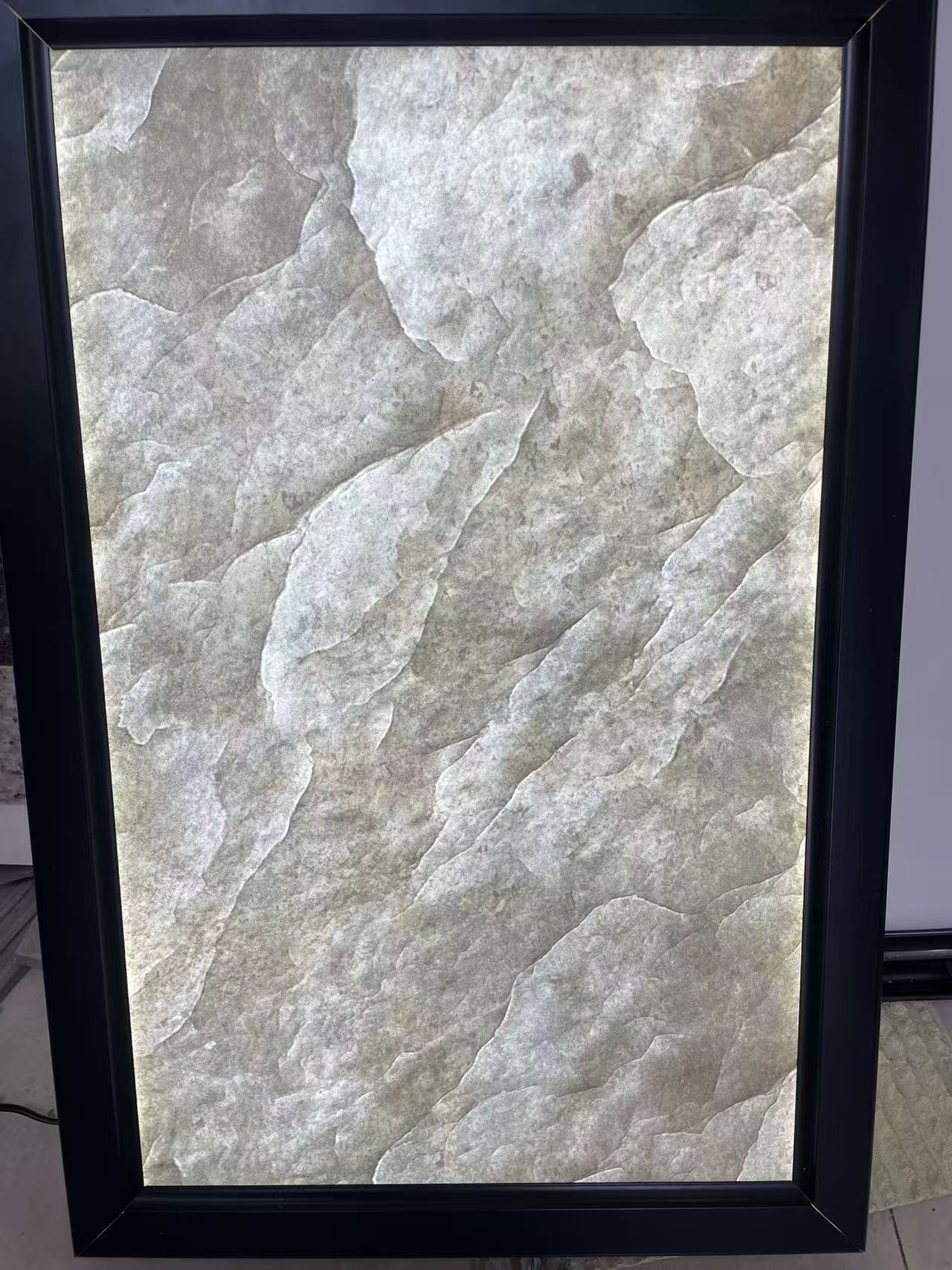 Translucent flexible stone panel photographed after light passes through