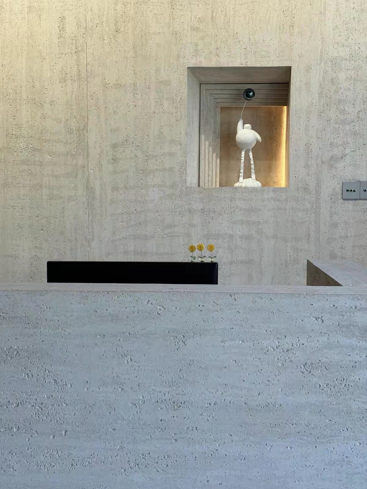 Minimalist hotel lobby clad with concrete style flexible stone wall panels