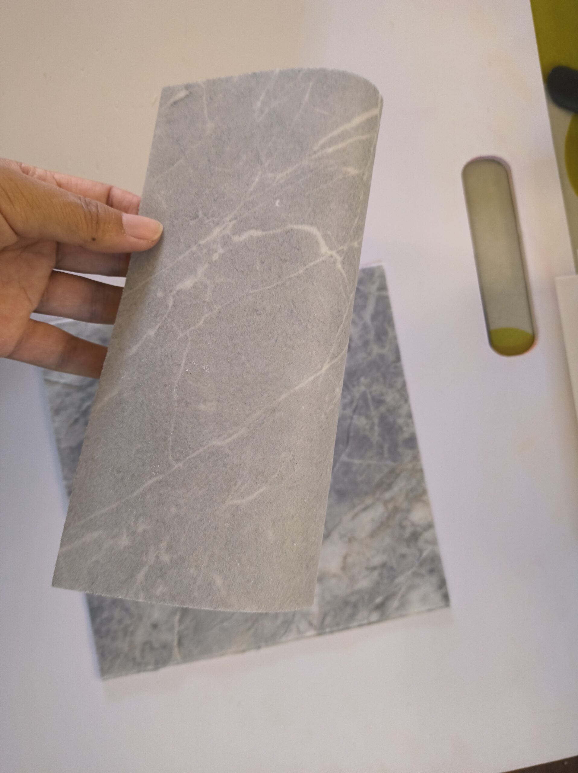 Translucent flexible stone panel backlit on a wall